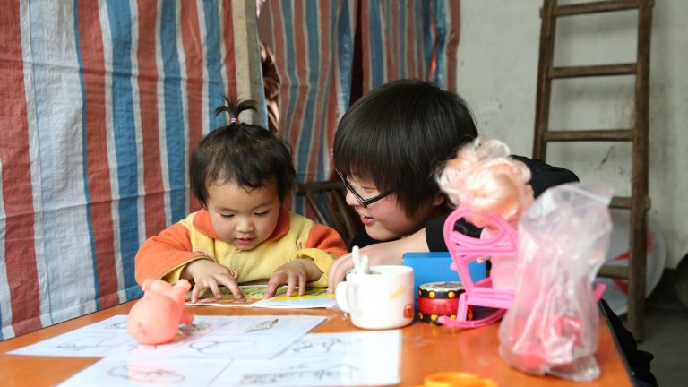 baby reading with trainer