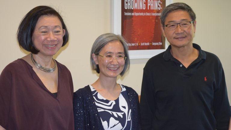 A Global Affiliate Visiting Fellow posing for the camera with APARC faculty Jean Oi and Xueguang Zhou.