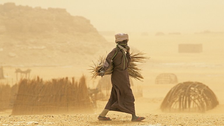 A man walks through a sandstorm in Chad
