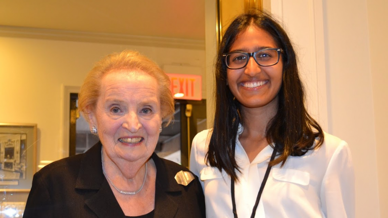 Stanford student and Global Policy Intern Kendra Mysore standing next to former U.S. Secretary of State Madeleine Albright.