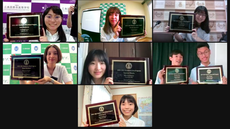 Photo of student honorees holding plaques
