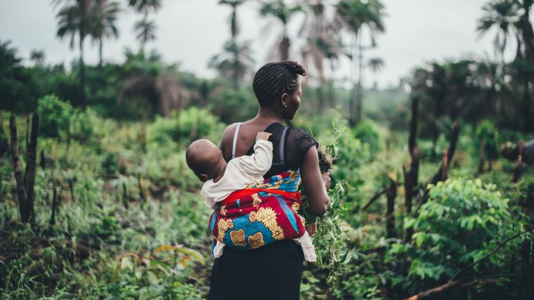 A mother and child in the fields in Sierra Leone.