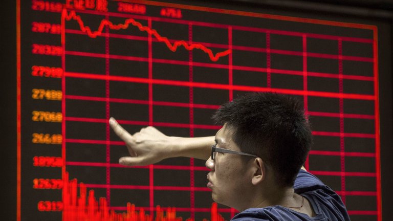 A Chinese day trader reacts as he watches a stock ticker at a local brokerage house on August 27, 2015 in Beijing, China