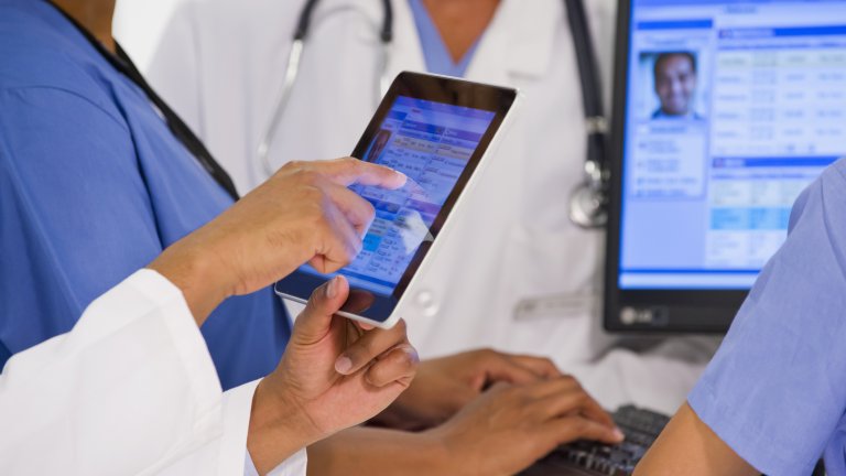 Health-care providers looking at electronic medical records