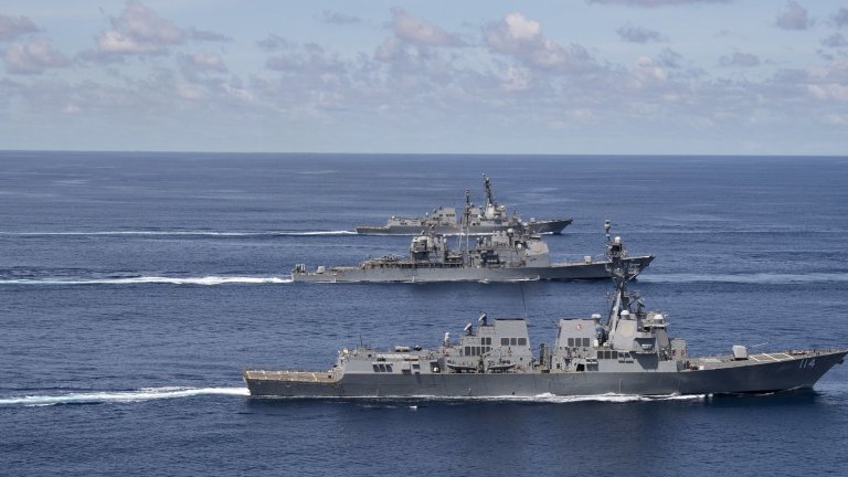 U.S. Navy and Indian Navy ships steam in formation in the Indian Ocean.