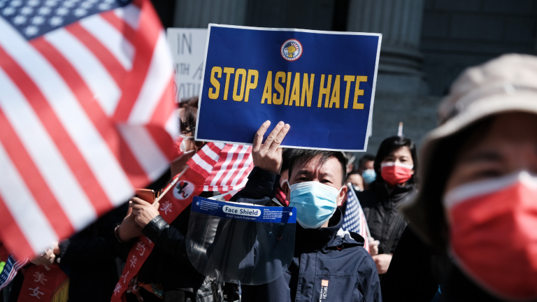 A man holds a 'Stop Asian Hate' sign during a rally protesting rising violence against Asian Americans.