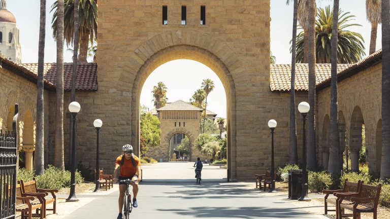 Student riding bicycle on Stanford University campus