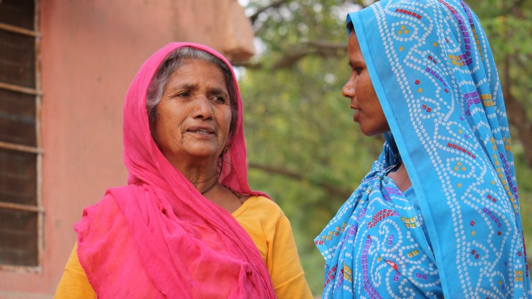 Two women standing in a street in Rajasthan, India