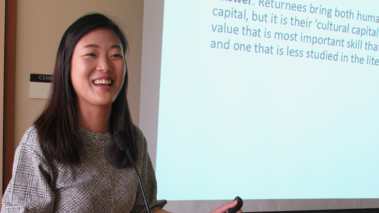 APARC visiting scholar Jane Yeonjae Lee delivering a seminar presentation, standing at a lectern.