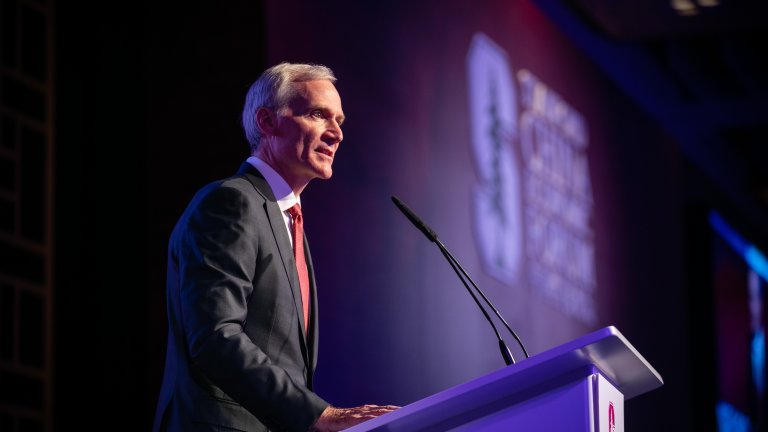 Marc Tessier-Lavigne speaks at a podium at the Stanford China Economic Forum.