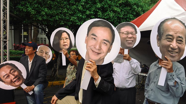 People hold pictures of Taiwanese presidential candidates People hold pictures of Taiwanese presidential candidates