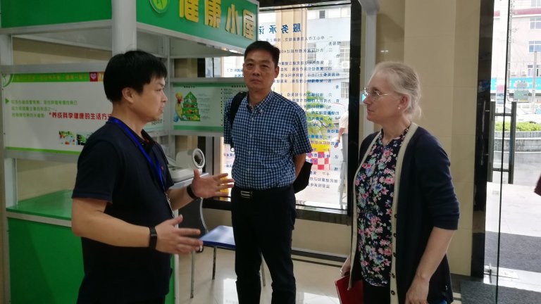 Asia Health Policy Program Director Karen Eggleston speaking with two researchers at the Zhejiang Provincial Center for Disease Control and Prevention, China.