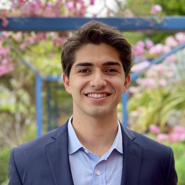 Headshot of Cooper DeNicola. Cooper is standing in front of a blurred background.