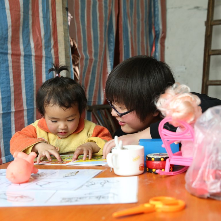baby reading with trainer
