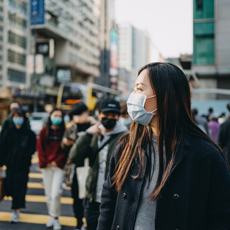 an image of an asian woman wearing a mask on the street
