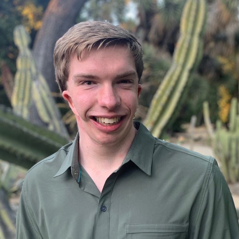 Headshot of Sean Gallagher. Sean is smiling in front of a blurred background.