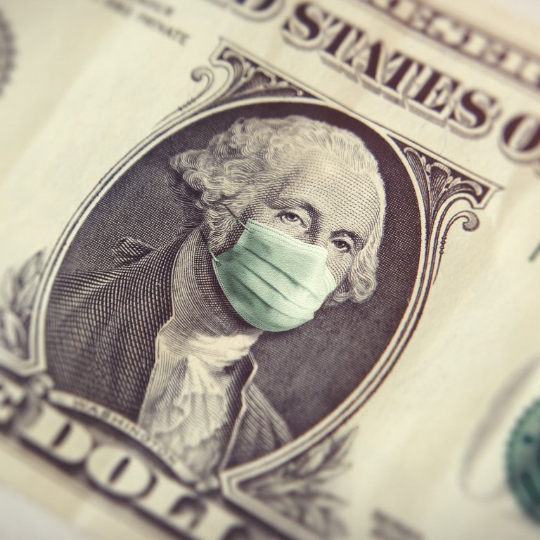 A dollar bill and mask represents the economy during COVID-19 pandemic.