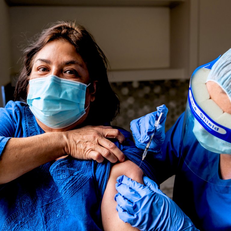Woman gets vaccinated.