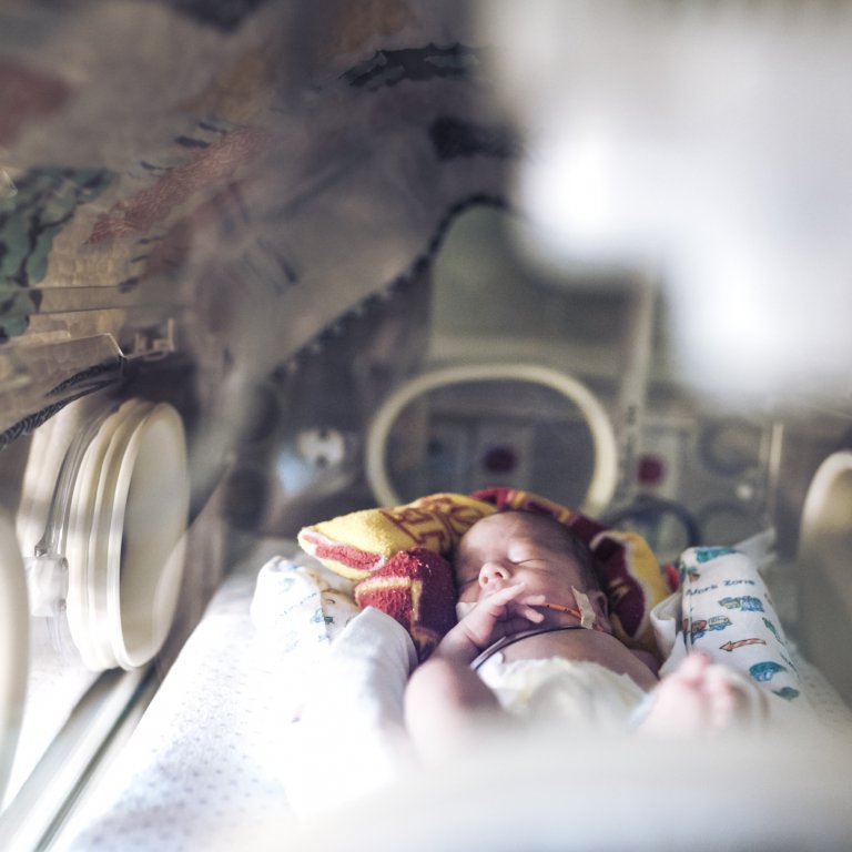 An infant in an incubator