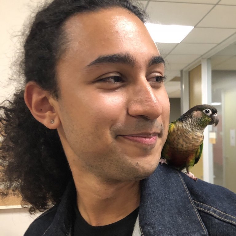 Headshot of George Hosono. George has a parrot on his shoulder.
