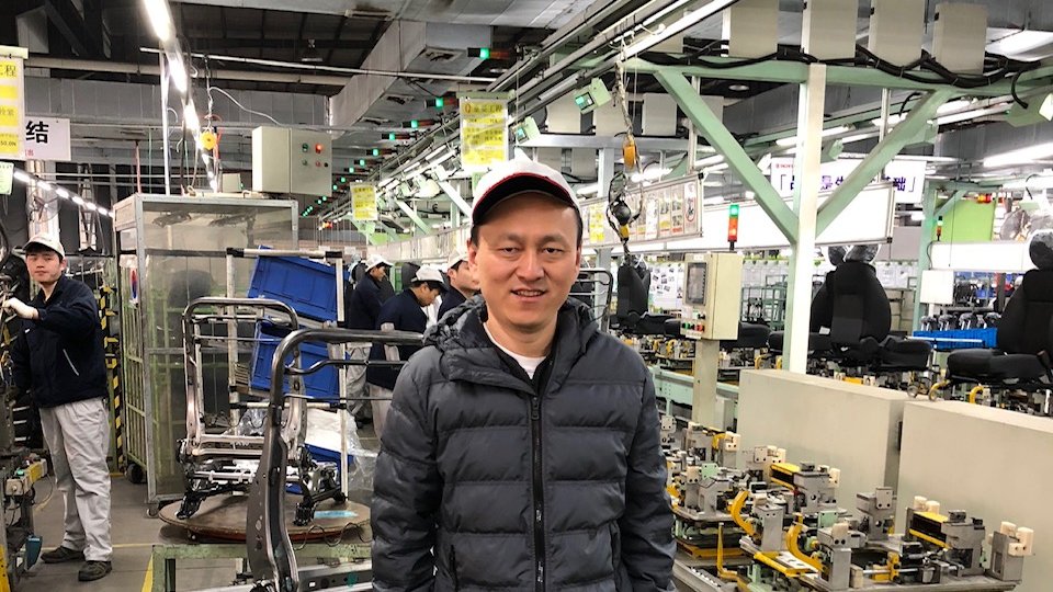Hongbin Li in a robotic factory in China.