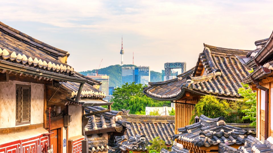 Bukchon Hanok Village with modern buildings in the background in Seoul, South Korea