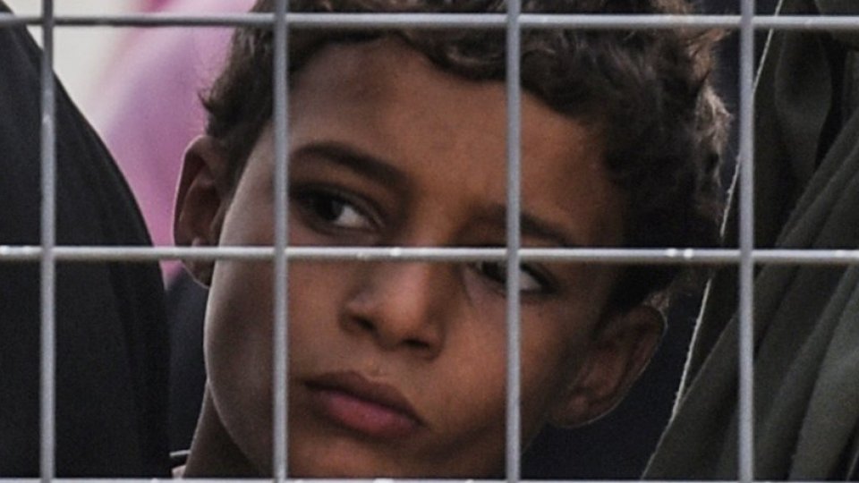 Child behind wire fence Child behind wire fence