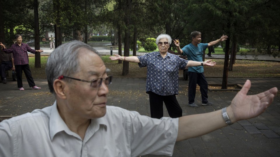 Elderly Chinese people practicing Tai Chi in a park