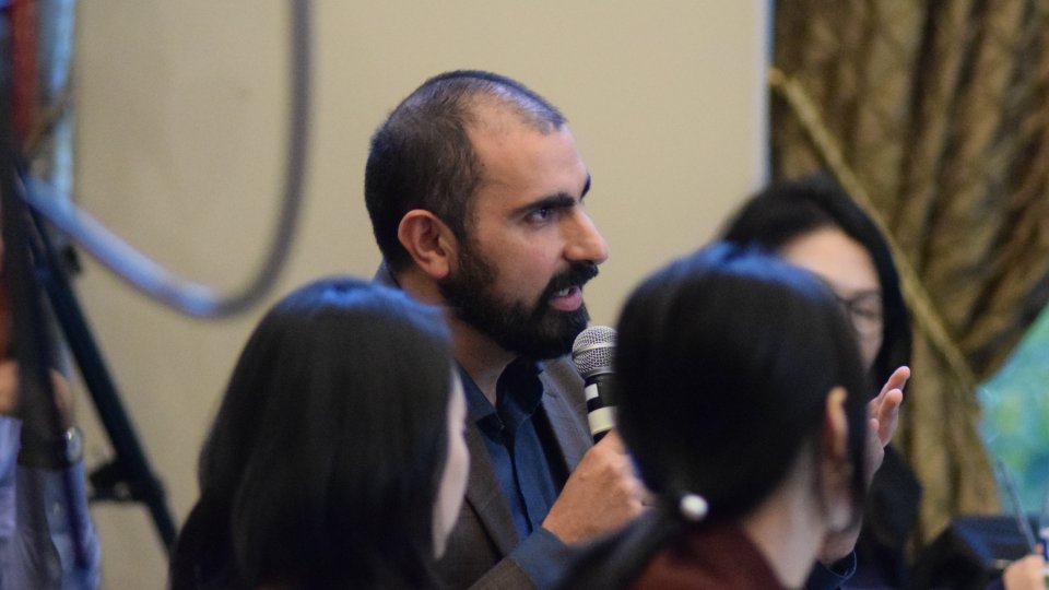 2018-19 Koret Fellow Andray Abrahamian presenting a question from the audience during a Korea Program conference