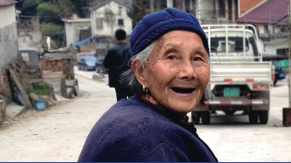 Elderly woman in a village setting
