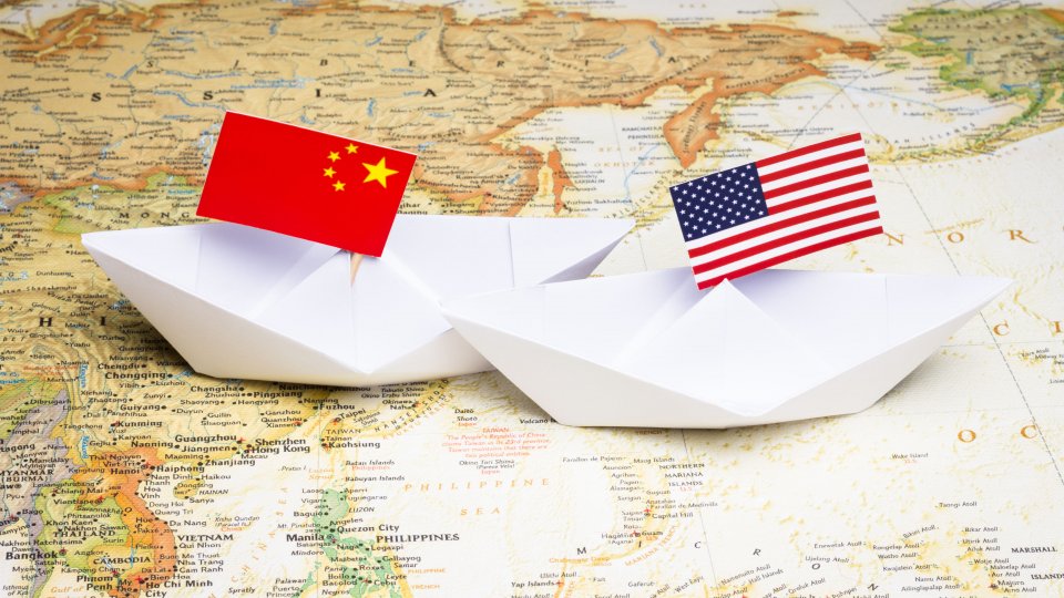 Paper boats with Chinese and American flags