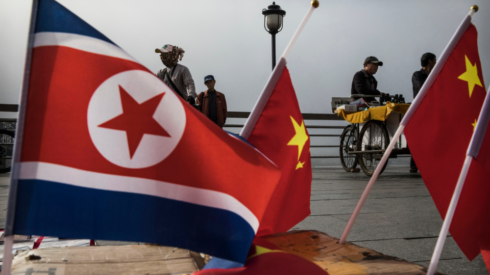 Small flags of North Korea and China for sale near the China-North Korea border