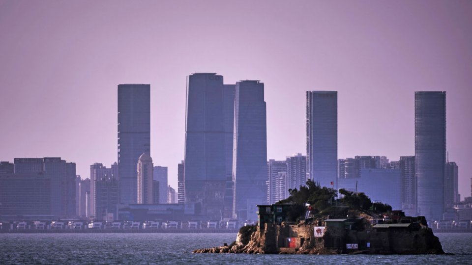 An Island that lies inside Taiwan's territory is seen with the Chinese city of Xiamen in the background.