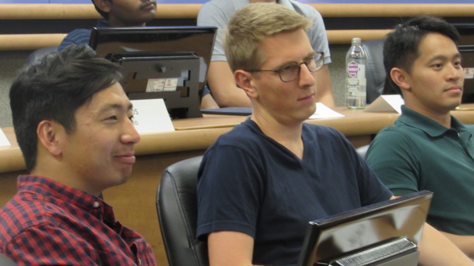 Students seated in a Stanford immersive classroom during an APARC-taught course interact with peers at Peking University using advanced technology.