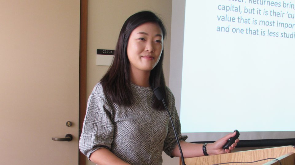 Jane Yeonjae Lee, visiting scholar with the Korea Program, speaking at a podium