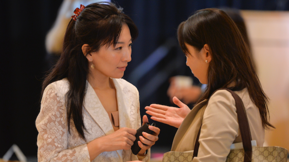Two Japan Program event attendees talk to one another