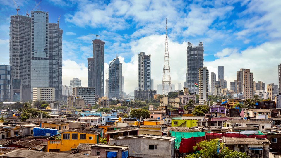 Views of slums on the shores of mumbai, India against the backdrop of skyscrapers under construction