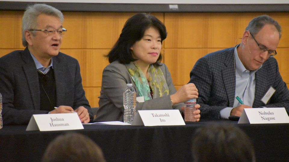 Three panelists, two males and a female, speaking at a Japan Program conference.