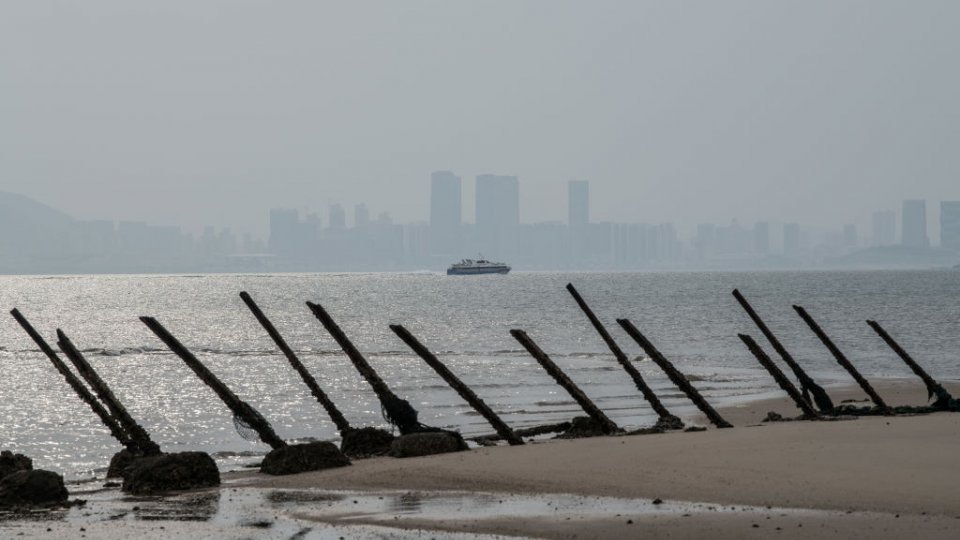 he Chinese city of Xamen is seen in the distance behind aged anti-landing barricades on a beach facing China on the Taiwanese island of Kinmen which, at points lies only a few miles from China, on April 19, 2018 in Kinmen, Taiwan.