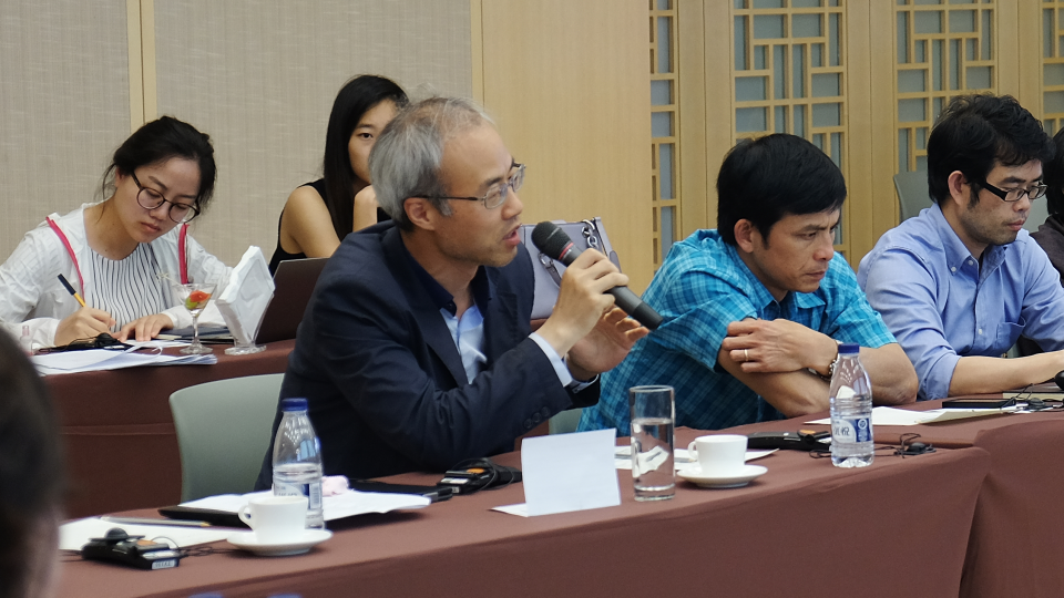 Participants at APARC's Asia Health Policy Program forum seated in a conference room during a presentation by one of the forum's speakers.