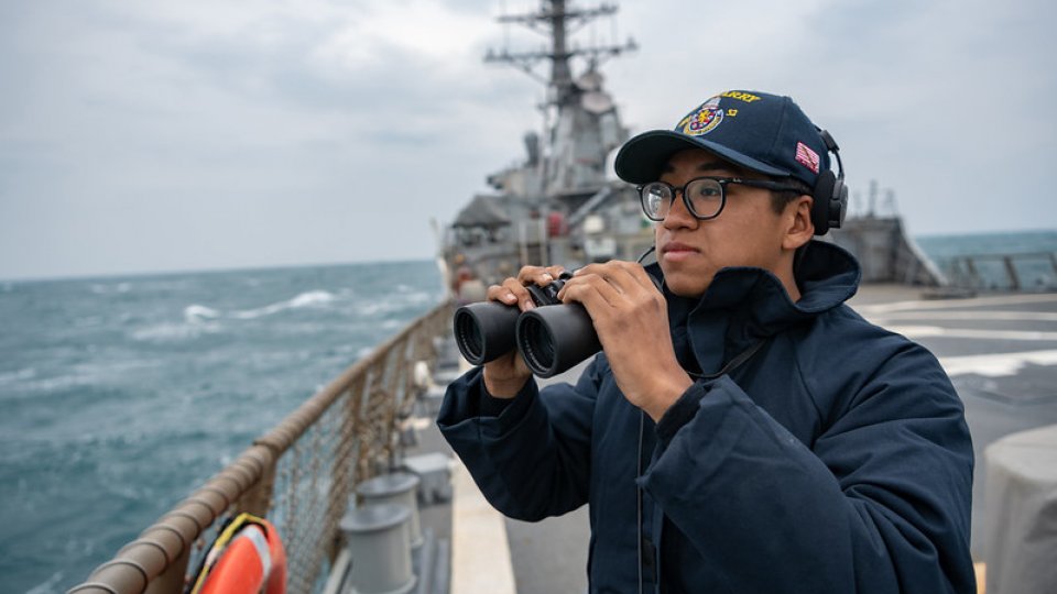 US Pacific Fleet seaman stands lookout on the flight deck as the Arleigh-Burke class guided missile destroyer USS Barry (DDG 52) transits the Taiwan Strait during routine underway operations.