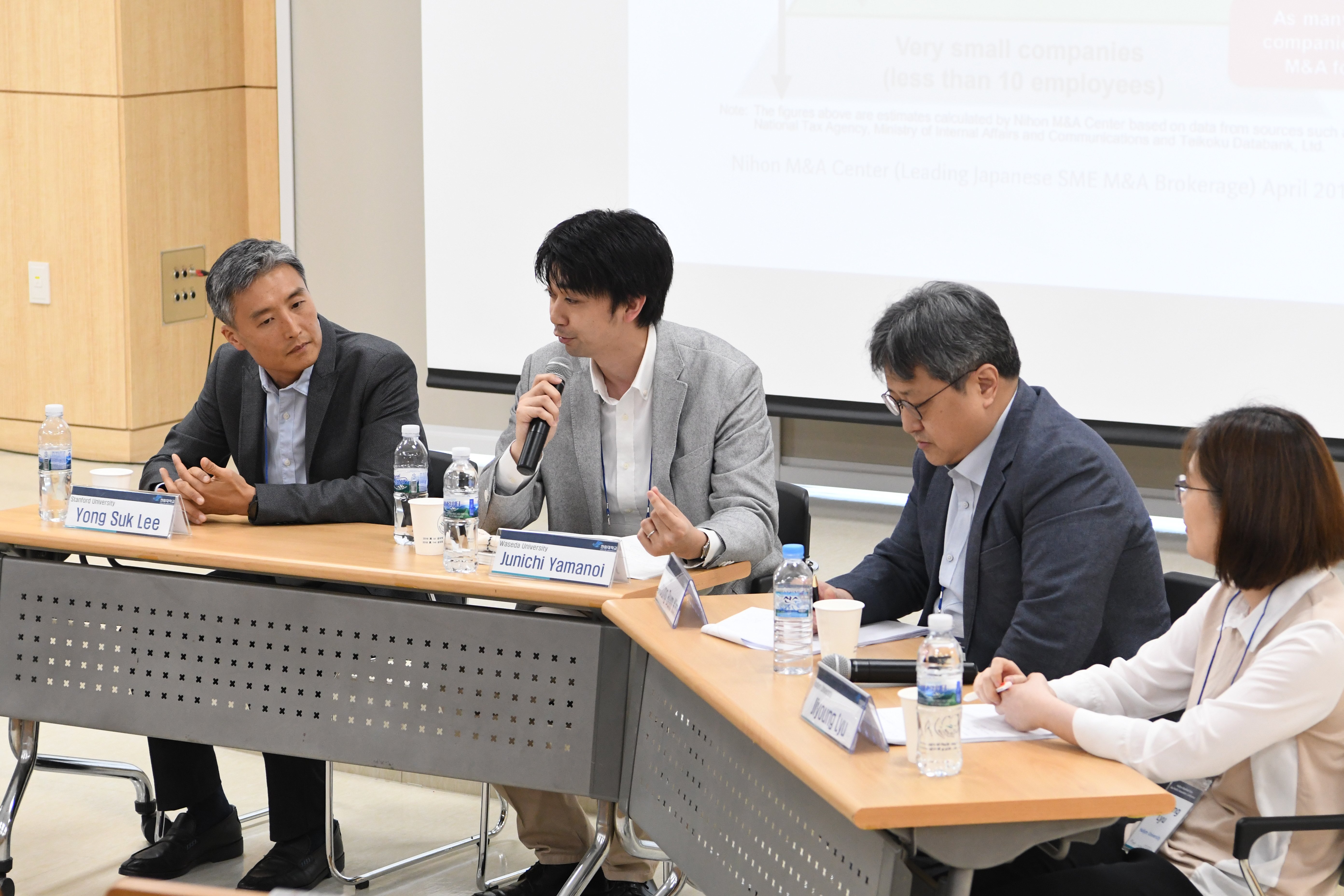  Yong Suk Lee , Junichi Yamanoi , Young-Bum Kim, and Jiyoung Liu seated at a table