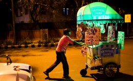 An ice cream vendor pushes his cart in front of Lodhi Gardens in New Delhi, India.