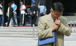 A man smokes in the street in Seoul, South Korea.