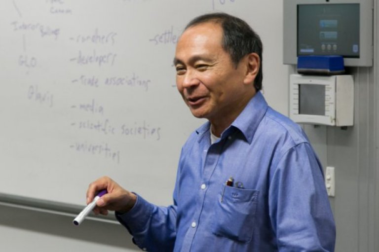 Francis Fukuyama teaching in front of a whiteboard