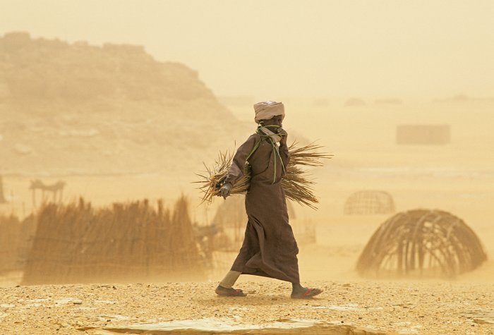 A man walks through a sandstorm in Chad