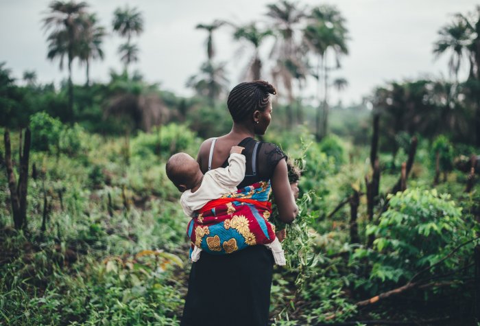 A mother and child in the fields in Sierra Leone.