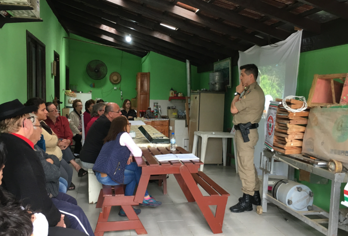 A law enforcement officer meets with community members in Brazil.
