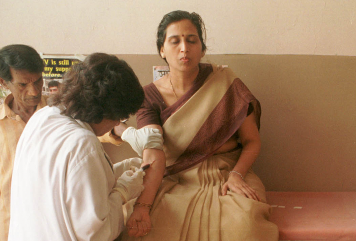 A woman has blood drawn at a clinic in Bombay, India