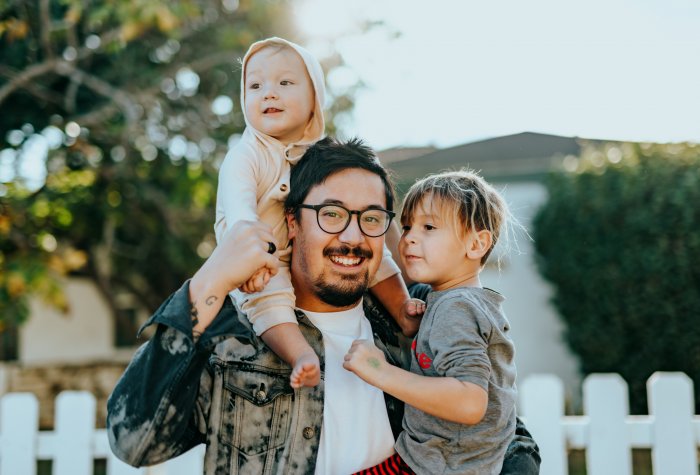 A father with his son and daughter (paid family leave)